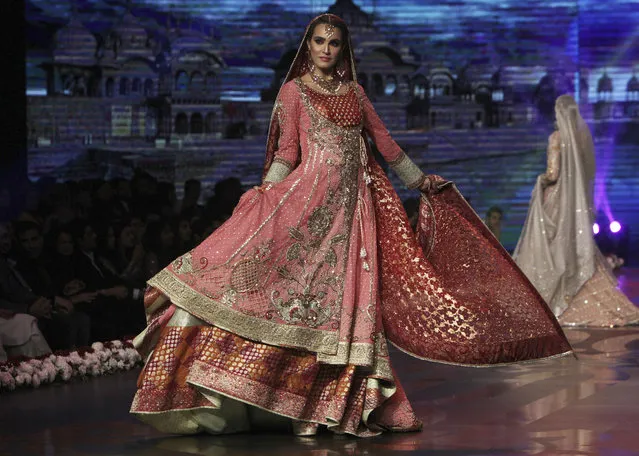 A model presents a bridal creation by designer Wardha Saleem during Bridal Couture Week 2016 in Lahore, Pakistan, Sunday, November 27, 2016. (Photo by K.M. Chaudary/AP Photo)
