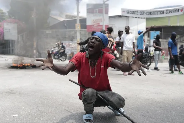 A man gestures after tear gas was fired by police during a protest against insecurity in Port-au-Prince, Haiti, Monday, August 14, 2023. (Photo by Joseph Odelyn/AP Photo)