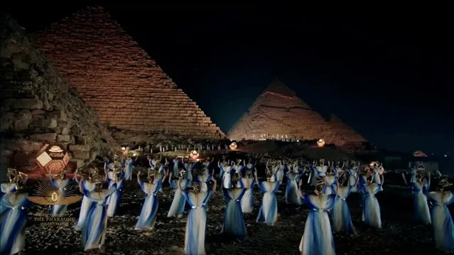 Artists perform near piramids in a video screened at a ceremony of a transfer of Royal mummies from the Egyptian Museum in Tahrir to the National Museum of Egyptian Civilization in Fustat, in Cairo, Egypt on April 3, 2021 in this screen grab taken from video. (Photo by Host Broadcaster/Reuters TV via Reuters)