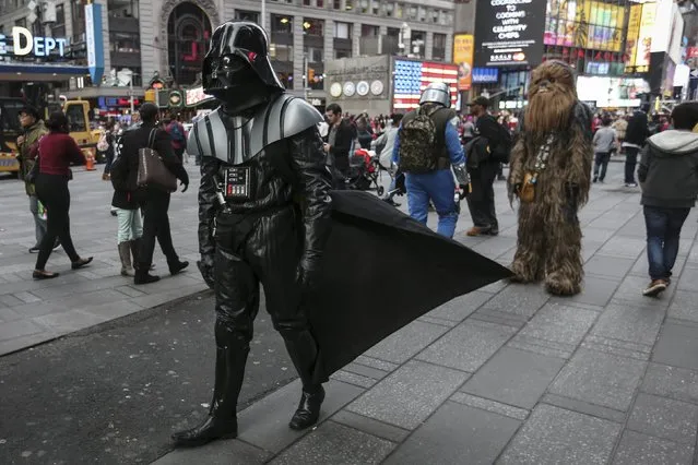 A man dressed as Darth Vader from Star Wars walks though Times Square during unseasonably warm weather on Christmas eve in the Manhattan borough of New York December 24, 2015. (Photo by Carlo Allegri/Reuters)
