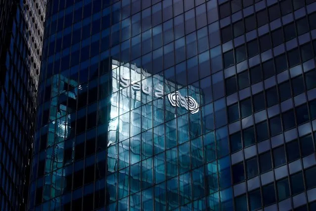 The reflection of the Suez logo is seen on the company headquarters at La Defense business and financial district in Courbevoie near Paris, France, April 12, 2021. (Photo by Gonzalo Fuentes/Reuters)