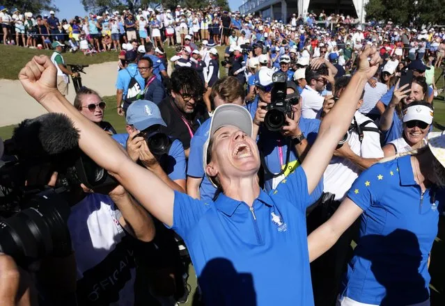 Members of the Europe team and supporters celebrate at the end of the match between Europe's Carlota Ciganda and United States' Nelly Korda at the Solheim Cup golf tournament in Finca Cortesin, near Casares, southern Spain, Sunday, September 24, 2023. Europe has beaten the United States during this biannual women's golf tournament, which played alternately in Europe and the United States. (Photo by Bernat Armangue/AP Photo)