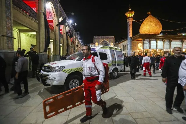 In this photo provided by Iranian Students' News Agency, ISNA, a medic carries a stretcher at Shah Cheragh shrine, the scene of a gunman attack in the southern city of Shiraz, Iran, Sunday, August 13, 2023. A gunman opened fire Sunday night at a prominent shrine in southern Iran, wounding at least four people, authorities said. Information on the attack at Shah Cheragh remained unclear immediately after the shooting, with state media and semiofficial news agencies offering differing details. (Photo by Mohammadreza Dehdari, ISNA via AP Photo)