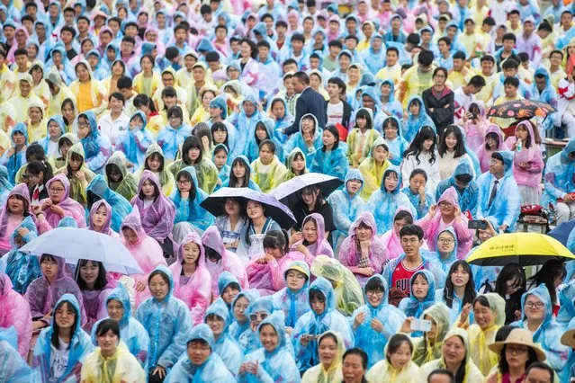 Students wearing raincoats attend a graduation ceremony after the 2021 National College Entrance Exam (aka Gaokao) at Minzu High School on June 9, 2021 in Bijie, Guizhou Province of China. (Photo by Luo Dafu/VCG via Getty Images)