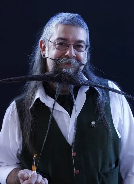 Charlie Savill of Britain poses before taking part in the Beard World Championship 2013 in Leinfelden-Echterdingen near Stuttgart November 2, 2013. More than 300 people from around the world compete in different moustache and beard categories. (Photo by Michaela Rehle/Reuters)
