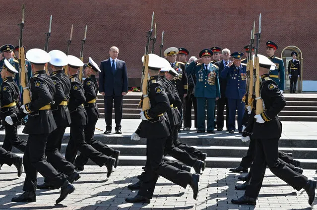 Russian President Vladimir Putin (C) attends a wreath-laying ceremony at the Tomb of the Unknown Soldier in the Alexandrovsky Garden near the Kremlin wall in Moscow, Russia, 22 June 2021, to commemorate those who lost their lives defending the Soviet Union against Nazi invaders. Russia marks the Day of Memory and Sorrow on 22 June. (Photo by Alexei Nikolsky/Sputnik/EPA/EFE)