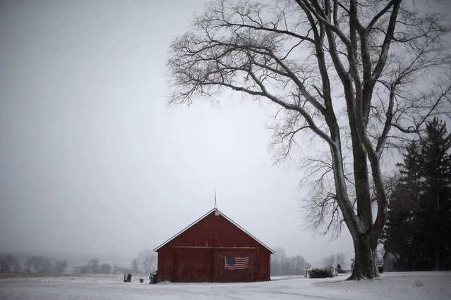 A U.S. flag hangs from a barn in Solon, Iowa, January 25, 2015. (Photo by Jim Young/Reuters)