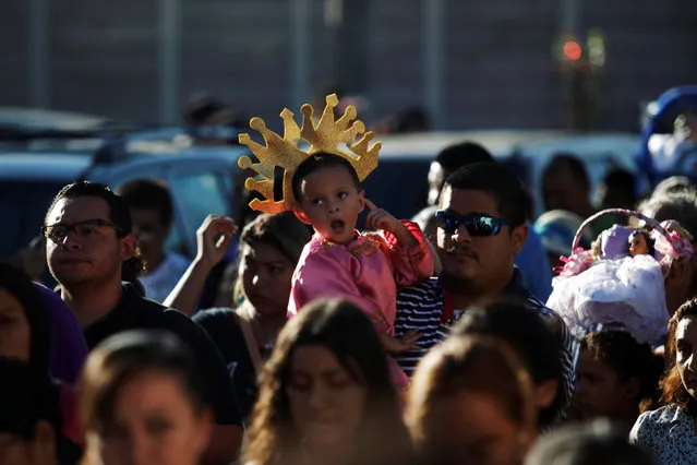 A child dressed as baby Jesus participates in a religious procession on Holy Innocents Day in Antiguo Cuscatlan, El Salvador, December 28, 2016. (Photo by Jose Cabezas/Reuters)