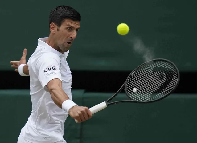 Serbia's Novak Djokovic plays a return to Canada's Denis Shapovalov during the men's singles semifinals match on day eleven of the Wimbledon Tennis Championships in London, Friday, July 9, 2021. (Photo by Kirsty Wigglesworth/AP Photo)