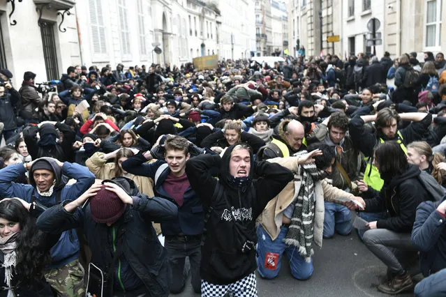 High school students demonstrate on their knees on December 11, 2018 in Paris, France, to protest against the different education reforms including the overhauls and stricter university entrance requirements. Images of dozens of high-school pupils kneeling with their hands behind their heads during mass round-ups sparked an outcry on December 7, 2018. Protests at some 280 schools have added to a sense of general revolt in France. (Photo by Stephane De Sakutin/AFP Photo)