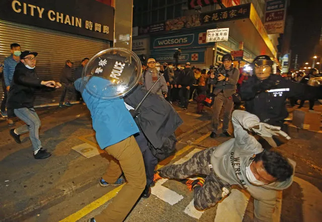 Rioters scuffle with police on a street in Mongkok district of Hong Kong, Tuesday, February 9, 2016. (Photo by Kin Cheung/AP Photo)