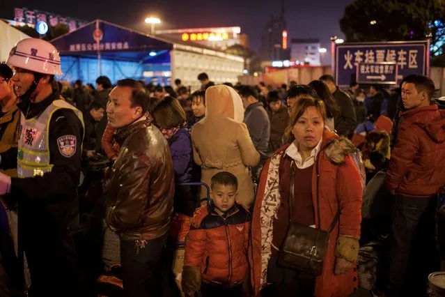 Passengers wait outside the Guangzhou Railway Station, Guangdong, China, February 2, 2016. (Photo by Zhong Ruijun/Reuters/Southern Metropolis Daily)