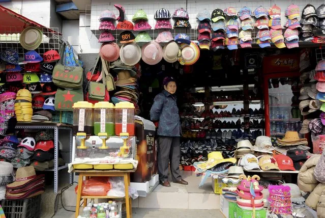 A vendor waits for customers at a shop in central Beijing, April 9, 2015. China's economy probably cooled further to grow 7 percent in the first three months of the year, a Reuters poll showed, which would be the weakest pace in six years and raise pressure on policymakers to do more to bolster growth. (Photo by Jason Lee/Reuters)