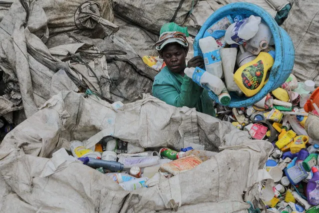 Kenyan women sort plastic waste products at a collection centre where they are later taken to a plastic recycling factory in Kariobangi, in Nairobi, Kenya, 03 December 2018. According to a report by the UN, the carbon dioxide (CO2) emissions have gone up for the first time in four years and that the year 2018 is set to be the fourth hottest year on record. The report comes just days ahead of the COP24 United Nations Climate Change Conference taking place in Poland from 02 to 14 December. (Photo by Daniel Irungu/EPA/EFE)