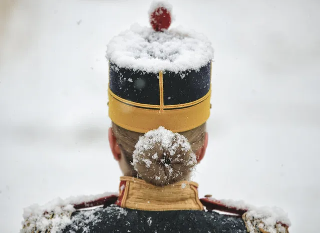 Snow falls on a honor guard soldier before the welcoming ceremony for Slovenia's President Borut Pahor at the Cotroceni presidential palace in Bucharest, Romania, Tuesday, January 15, 2019. (Photo by Vadim Ghirda/AP Photo)