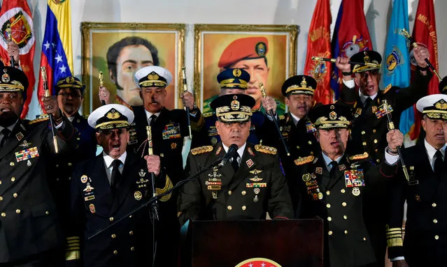 Venezuelan Defense Minister Vladimir Padrino Lopez (C) delivers a press conference in Caracas, along with members of the top military leadership “in support of the constitutional president”, Nicolas Maduro on January 24, 2019. Venezuelan leader Nicolas Maduro prepared to rally his military supporters Thursday as the US and key allies backed a challenge from his leading rival who declared himself “acting president”. Padrino Lopez said the military would show “backing for the sovereignty” of Venezuela. (Photo by Luis Robayo/AFP Photo)