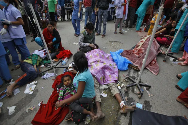 Injured people receive treatment outside Medicare Hospital in Kathmandu, Nepal, Saturday, April 25, 2015. (Photo by Niranjan Shrestha/AP Photo)