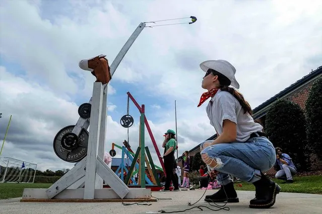 Alivia Templeton fires her trebuchet “Silver” for a throw dressed as the Lone Ranger during the 16th Annual Boyd Buchanan high school Physics Trebuchet & Catapult Competition on Monday, October 11, 2021 in Chattanooga, Tenn. (Photo by Troy Stolt/Chattanooga Times Free Press via AP Photo)