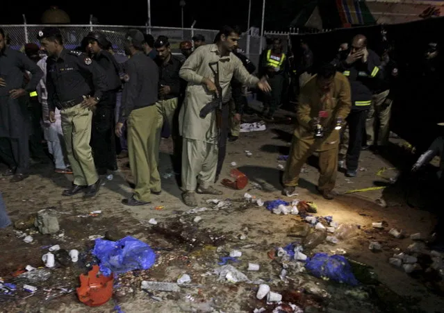 Security officials gather at the site of a blast outside a public park in Lahore, Pakistan, March 27, 2016. (Photo by Mohsin Raza/Reuters)