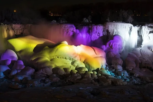 A partially frozen Niagara Falls is seen on the American side lit by lights during sub freezing temperatures in Niagara Falls. (Photo by Mark Blinch/Reuters)