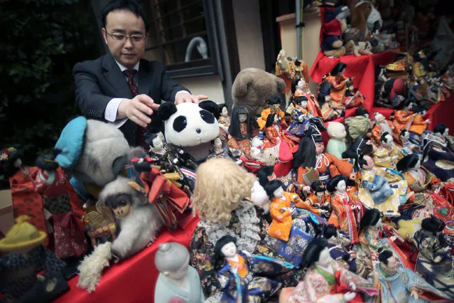 Visitors look at sacrificed dolls during the Festival of Repayment of Kindness at Dairoku-tensakaki Shrine in Tokyo, Saturday, May 16, 2015. (Photo by Eugene Hoshiko/AP Photo)