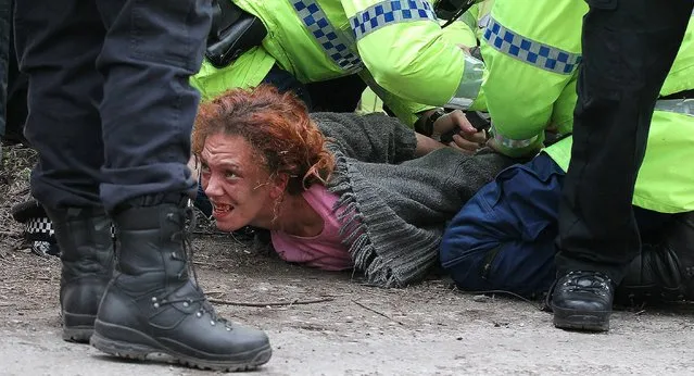 Protesters clash with police at the Barton Moss fracking site, Manchester, on March 17, 2014. (Photo by Lynne Cameron/PA Wire)