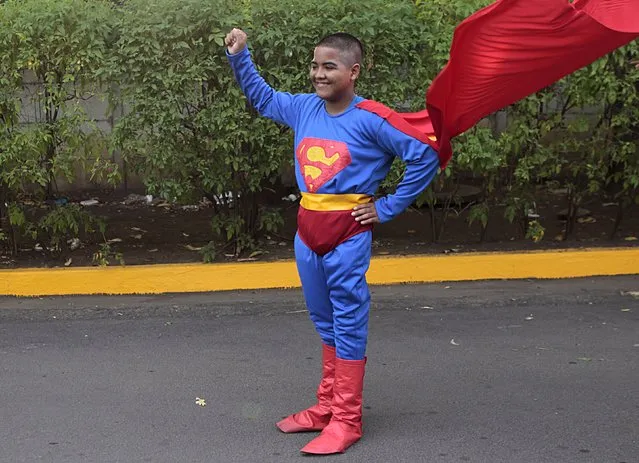 A boy who has cancer poses for a picture while dressed as Superman before a charity run raising funds for the treatment of children with cancer at a children's hospital in Managua May 17, 2015. (Photo by Oswaldo Rivas/Reuters)