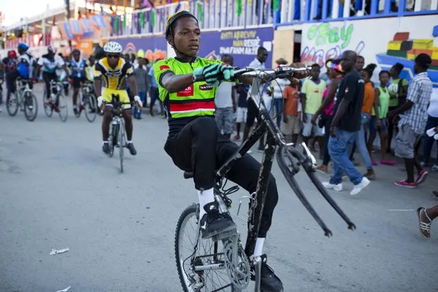 Bicyclists ride in the Carnival parade in Les Cayes, Haiti, Monday, February 27, 2017. (Photo by Dieu Nalio Chery/AP Photo)