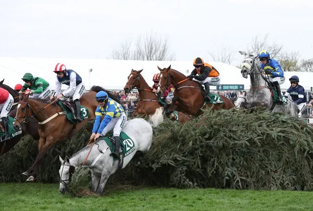 Riders clear an obstacle during the Randox Supports Race Against Dementia Topham Handicap Chase during “Ladies Day” at the Randox Grand National Festival at Aintree Racecourse in Liverpool, Britain, 12 April 2024. The Grand National Festival is held over three days, culminating in the world famous 6.9 kilometre handicapped steeplechase, running for the 176th time in 2024. (Photo by Adam Vaughan/EPA/EFE/Rex Features/Shutterstock)