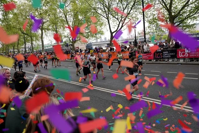 Confetti is fired by people watching the masses on the Embankment during the TCS London Marathon on Sunday, April 21, 2024. (Photo by Yui Mok/PA Images via Getty Images)