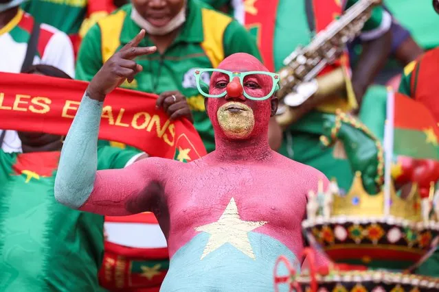 A football fan painted with the colours of the Burkina Faso national flag gestures ahead of the opening ceremony of the Africa Cup of Nations (CAN) 2021 football tournament at Stade d'Olembé in Yaounde on January 9, 2022. (Photo by Kenzo Tribouillard/AFP Photo)