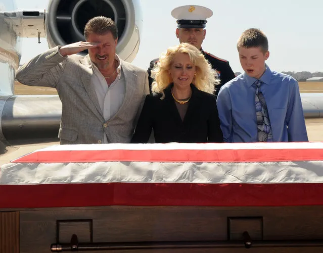 A father salutes the casket of his son March 23, 2011. Buckley Air Force Base honored Lance Cpl. Christopher Mies when he arrived home. (Photo by Senior Airman Marcy Glass/460th Space Wing Public Affairs)