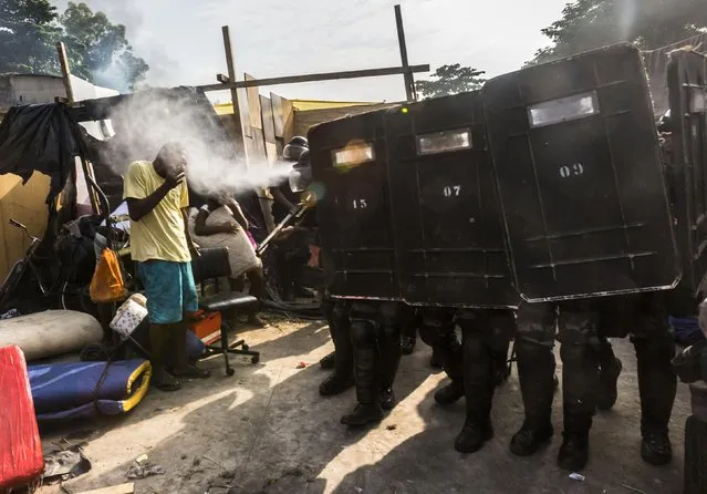 Riot police use tear gas to get people to leave the area in Rio de Janeiro, Brazil, on April 11, 2014. (Photo by Ana Carolina Fernandes/Reuters)