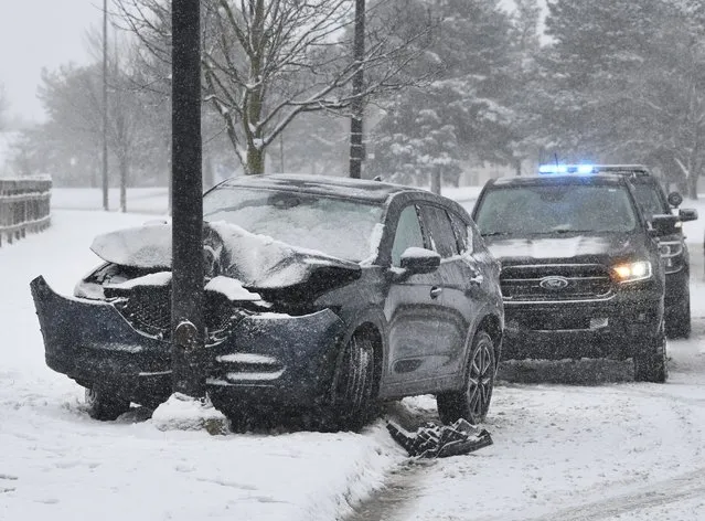 A vehicle's air bags are deployed after a collision on a snowy W. Eisenhower Parkway in Ann Arbor, Mich., on Wednesday, February 2, 2022. (Photo by Daniel Mears/Detroit News via AP Photo)