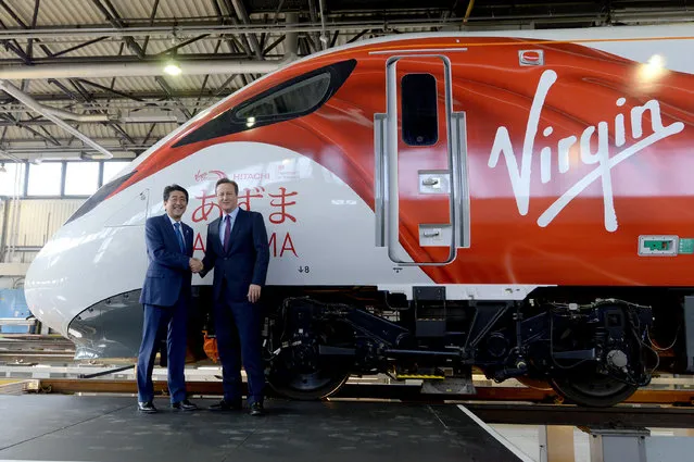 Prime Minister David Cameron (R) and Japanese Prime Minister Shinzo Abe during a tour of the Hitachi North Pole train maintenance Depot in West London, as Abe has warned that Brexit would make the UK “less attractive” to Japanese investors, May 5, 2016. (Photo by Anthony Devlin/Reuters)