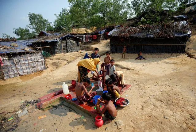 Rohingya refugees take bath and collect water from a tube-well at Balukhali Makeshift Refugee Camp in Cox's Bazar, Bangladesh, April 9, 2017. (Photo by Mohammad Ponir Hossain/Reuters)