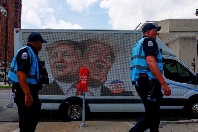 People walk next to a van with images of former President Donald Trump, as demonstrators and members of the Coalition to March on the RNC hold a rally in Milwaukee, Wisconsin on July 15, 2024. (Photo by Evelyn Hockstein/Reuters)