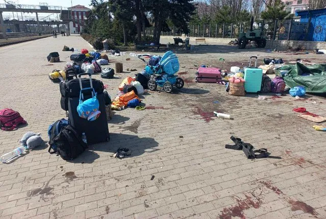 In this photo published on Ukrainian President Volodymyr Zelenskyy's Telegram channel, blood stains are seen among bags and a baby carriage on a platform after Russian shelling at the railway station in Kramatorsk, Ukraine, Friday, April 8, 2022. (Photo by Ukrainian President Volodymyr Zelenskyy's Telegram channel via AP Photo)