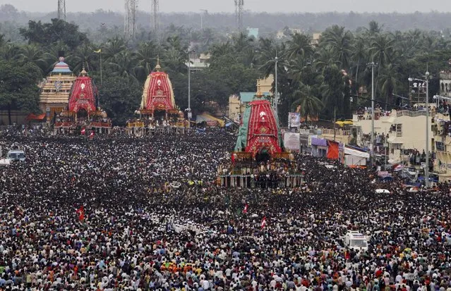 Devotees thong around chariots of the deities of Lord Jagannath Hindu temple during the return chariot festival at Puri, Orissa state, India, Sunday, July 26, 2015. (Photo by Biswaranjan Rout/AP Photo)
