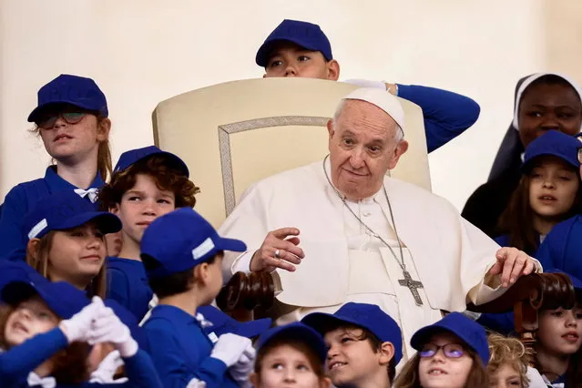 Pope Francis greets children after the the weekly general audience at Saint Peter's Square at the Vatican on May 4, 2022. (Photo by Yara Nardi/Reuters)