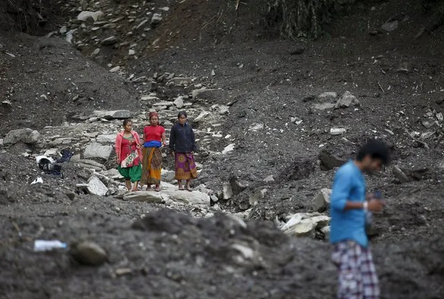 People observe the landslide-affected area after the landslide at Lumle village in Kaski district July 30, 2015. (Photo by Navesh Chitrakar/Reuters)