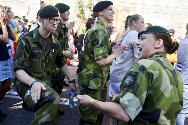 Army personnel attend the annual gay pride parade march in Stockholm, Sweden, August 1, 2015. (Photo by Vilhelm Stokstad/Reuters/TT News Agency)