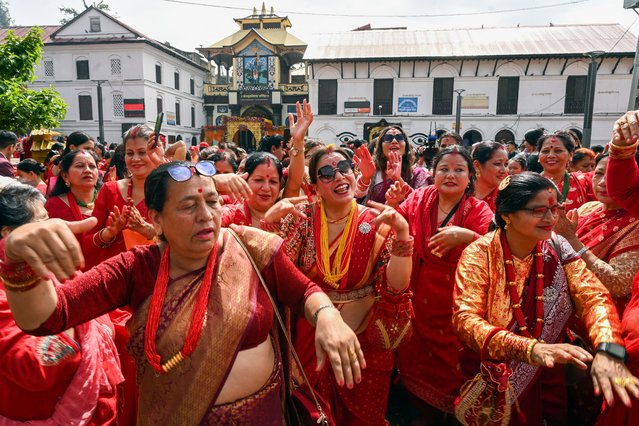 Women dance after offering prayers to Hindu deity Shiva, as they mark “Teej” festival at Pashupatinath temple in Kathmandu on September 6, 2024. (Photo by Prakash Mathema/AFP Photo)