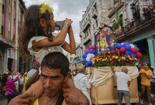 People of faith take part in a procession honoring Cuba's patron saint, Our Lady of Charity of Cobre, on her feast day in Havana, Sunday, September 8, 2024. (Photo by Ramon Espinosa/AP Photo)