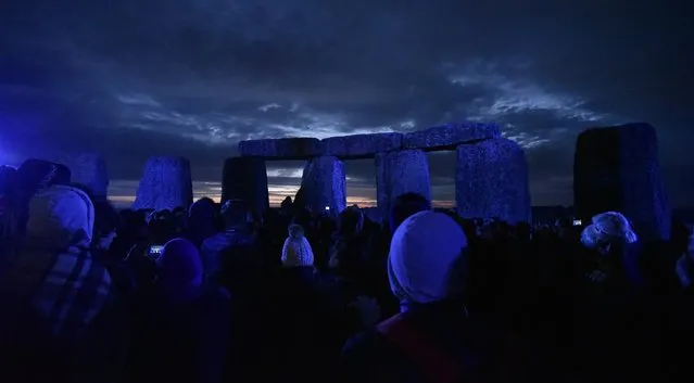 People gather to watch the sunrise on the longest day of the year during the summer solstice at the Stonehenge in Wiltshire, Britain, 21 June 2016. (Photo by Neil Munns/EPA)