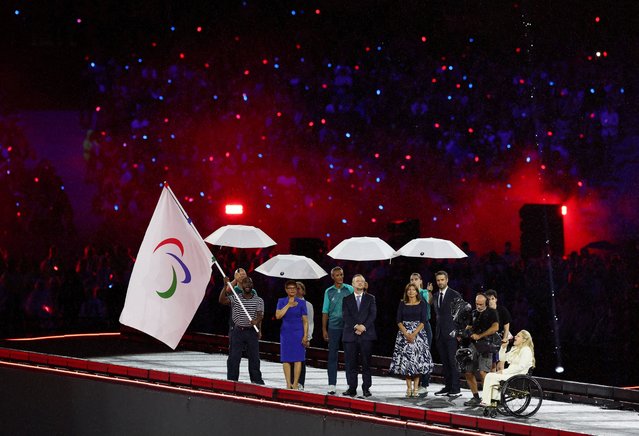 American athlete Blake Leeper is handed the Paralympic flag by Karen Bass, Mayor of Los Angeles during the Paris 2024 Paralympic Games Closing Ceremony on day eleven of the Paris 2024 Summer Paralympic Games on September 8, 2024 in Paris, France. (Photo by Umit Bektas/Reuters)