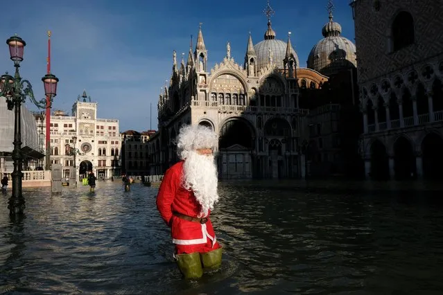 A man dressed as Santa Claus wades through floodwater in St. Mark's Square during high tide in Venice, Italy, December 23, 2019. (Photo by Manuel Silvestri/Reuters)