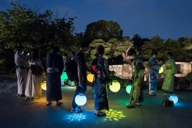 Guest attendees hold lanterns during a preview of the Naked Summer Festival 2022 at Nijo-jo Castle on July 21, 2022 in Kyoto, Japan. (Photo by Tomohiro Ohsumi/Getty Images)