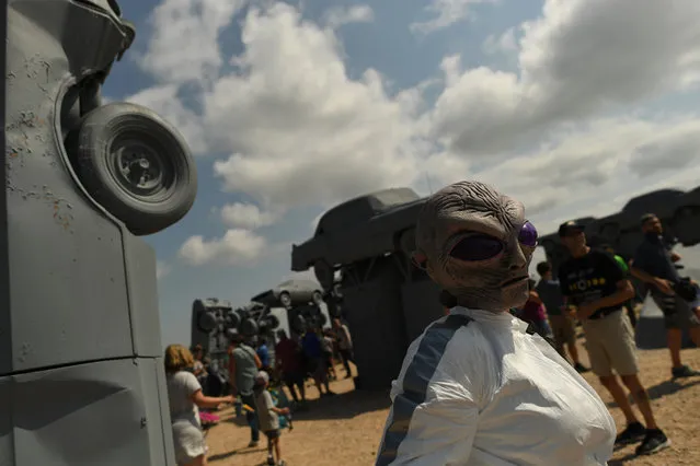 Humans and aliens gathered to watch the total solar eclipse, at Carhenge, on August 21, 2017 in Alliance, Nebraska. (Photo by RJ Sangosti/The Denver Post)