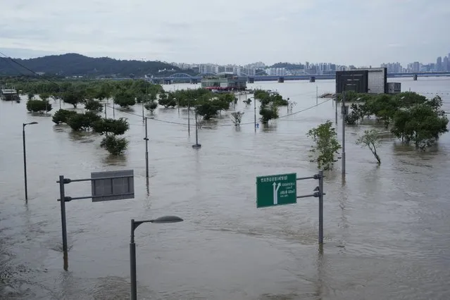 A part of a park along the Han River are flooded due to heavy rain in Seoul, South Korea, Wednesday, August 10, 2022. Cleanup and recovery efforts gained pace in South Korea's greater capital region Wednesday as skies cleared after two days of record-breaking rainfall that unleashed flash floods, damaged thousands of buildings and roads and killed multiple people. (Photo by Ahn Young-joon/AP Photo)